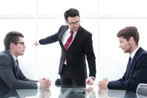 angry boss points an incompetent employee to the door.the concept of professionalism